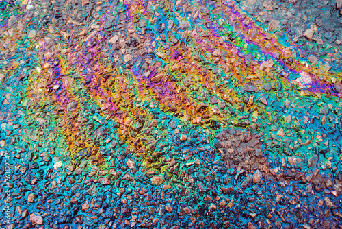 Leaked Gasoline Oil Slick or Petrol Rainbow Enviromental leak On Tarmac Road © squeebcreative