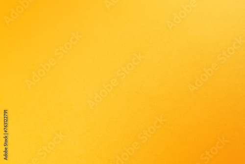Bright fresh yellow orange tone color paint on environmental friendly cardboard box blank paper texture background with space minimal style joyful concept