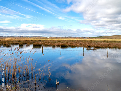 Sky reflected in the wetland at St Aidan's Nature Park, West Yorkshire, England