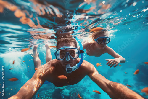 Happy family - father, mother, child in snorkeling mask dive underwater with tropical fishes in coral reef sea pool