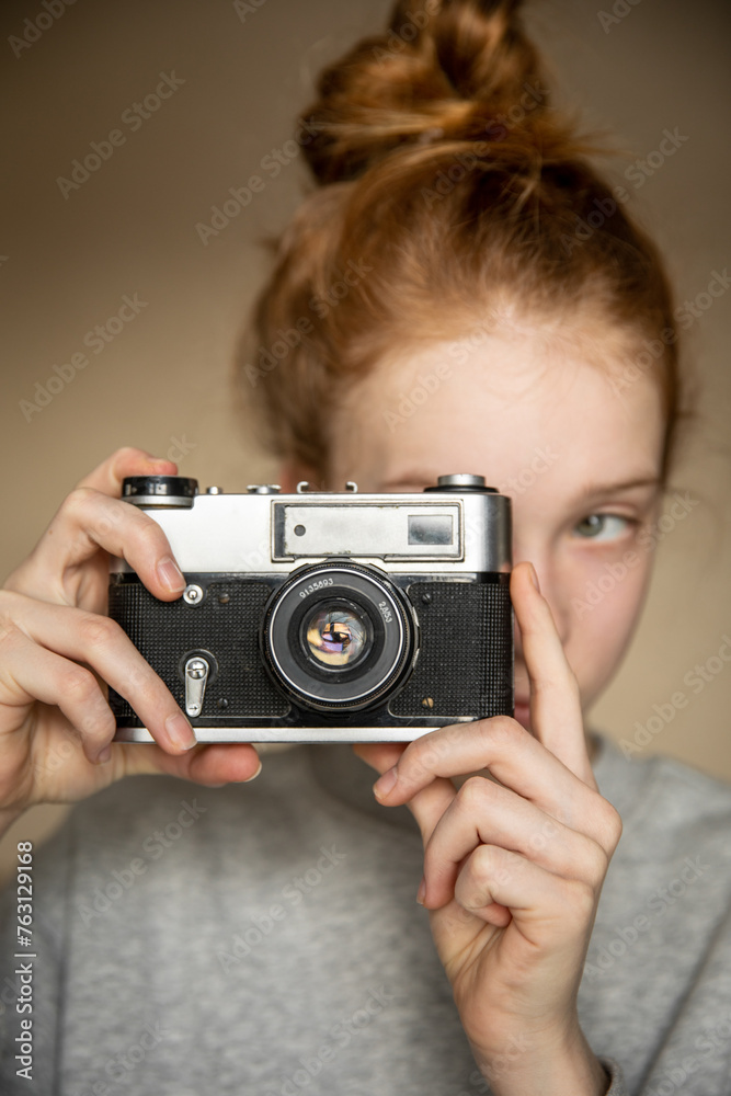 Film retro camera in the beautiful hands of a young red-haired girl Film retro camera in the beautiful hands of a young red-haired girl