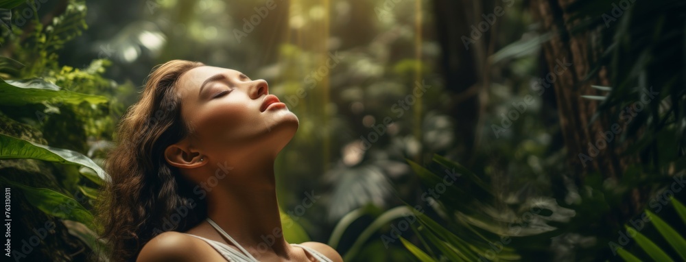 beautiful young woman is breathing deeply with closed eyes in jungle beautiful young woman is breathing deeply with closed eyes in jungle