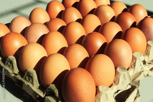 Chicken eggs neatly arranged on egg box.  with sunlight in the morning. as background and wallpaper photo