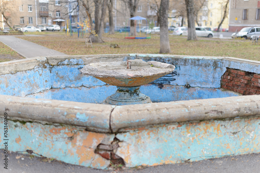 An old abandoned fountain in the center of a small town