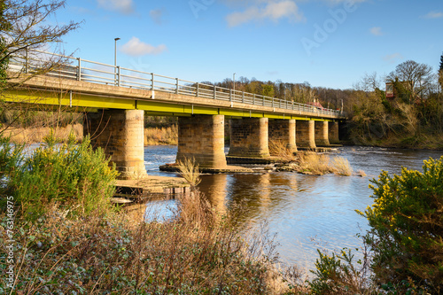 River Tyne flows below Wylam Bridge.  The River Tyne at Wylam located in Northumberland on the tree-lined riverbanks of the Tyne Valley
