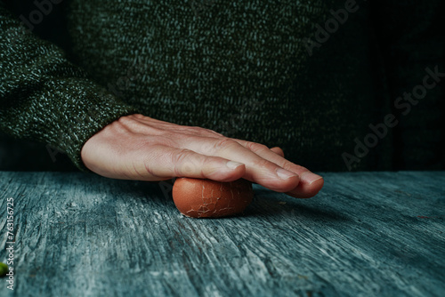 man rolling a hard-boiled egg © nito