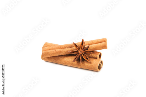Fototapeta Naklejka Na Ścianę i Meble -  Cinnamon sticks and anise isolated on white background. Cinnamon roll and star anise. Spicy spice for baking, desserts and drinks. Fragrant ground cinnamon.