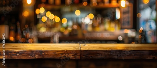 A wooden table blending with the blurred background of a city bar at night, illuminated by automotive lighting. The scene combines elements of wood, metal, asphalt, and entertainment photo