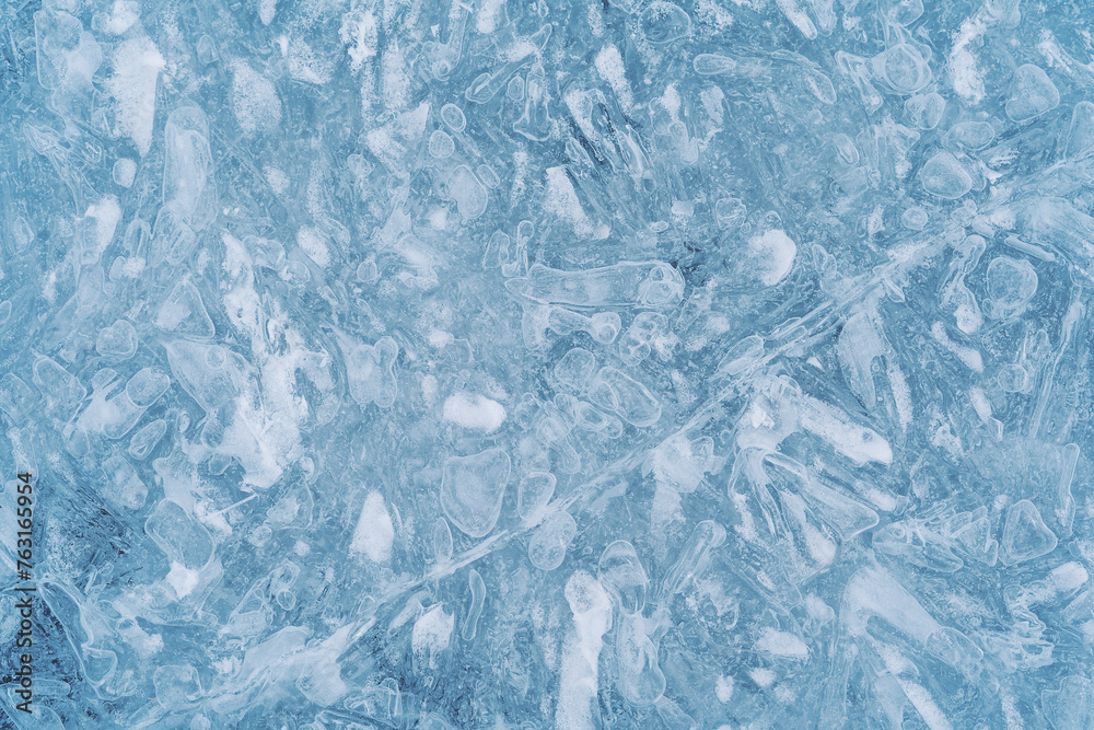 Obraz premium Close-up photo of transparent light blue ice of Baikal lake with white frost ornament. Great backdrop for your design with copy space. Top view.