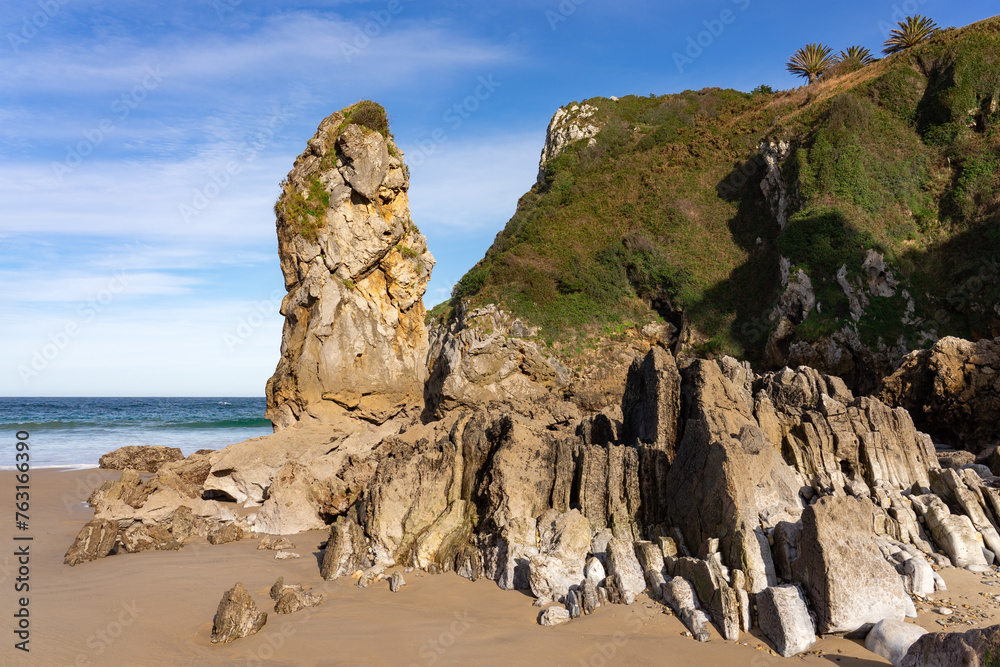 Amio beach with the cliffs and rock formations at sunset in Cantabria, Spain