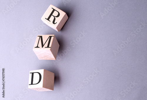 RMD word on wooden block on gray background