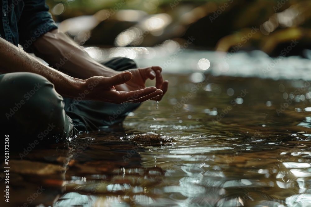 A person practicing mindfulness meditation in a stream of water, focusing on mental wellness and self-care
