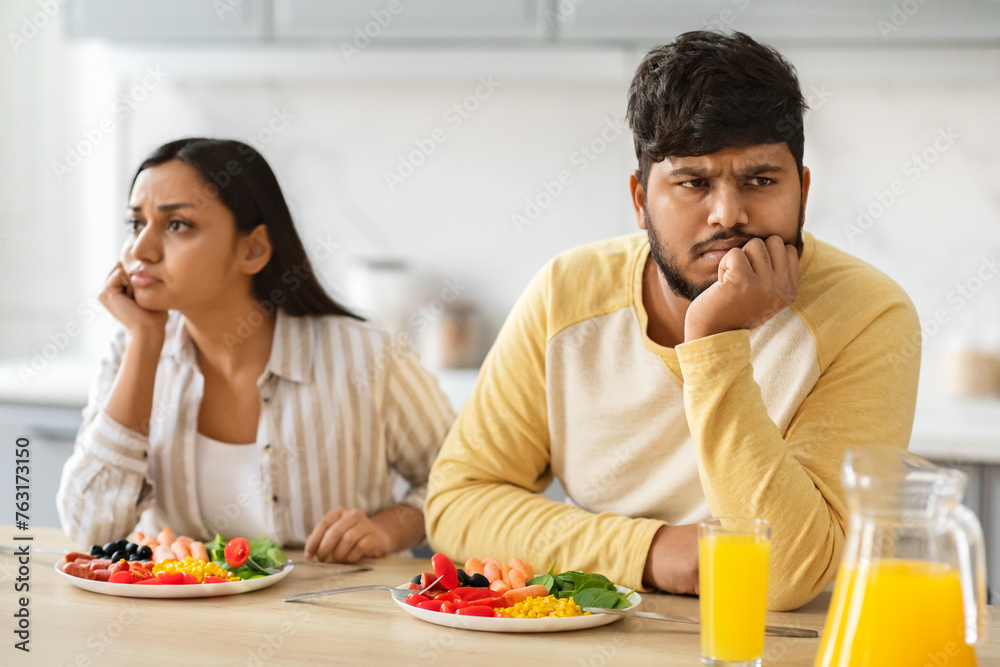 Frustrated indian husband and wife have fight during breakfast
