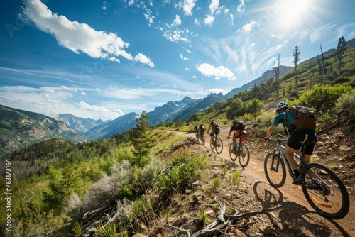 A group of people, riding bicycles, travel down a dirt road in a scenic outdoor setting, enjoying the thrill of cycling