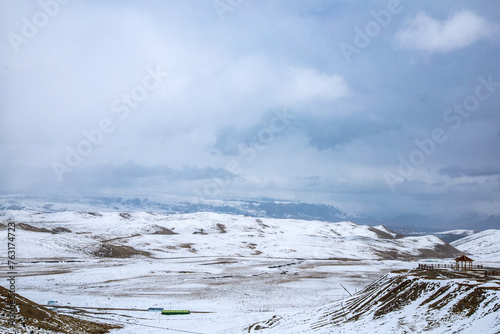 Gannan Tibetan Autonomous Prefecture, Gansu Province-Grassland under the snow-capped mountains photo