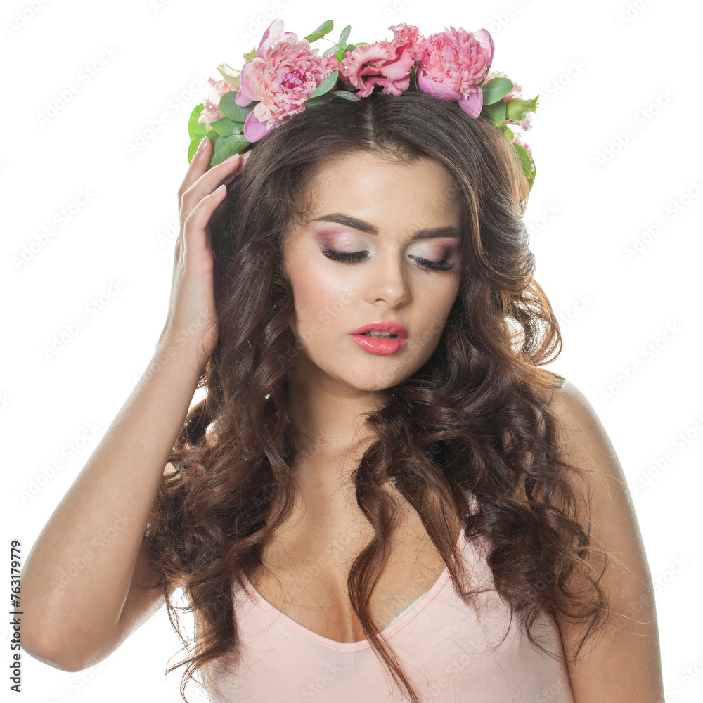 Lovely summer woman with long dark wavy hair, clean shiny skin and pink flower crown, studio portrait. Cosmetic, happiness, beauty and fashion concept