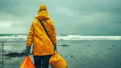 The solemn undertaking of nature's guardian. Beach cleaners wearing coats are walking on the shore photo