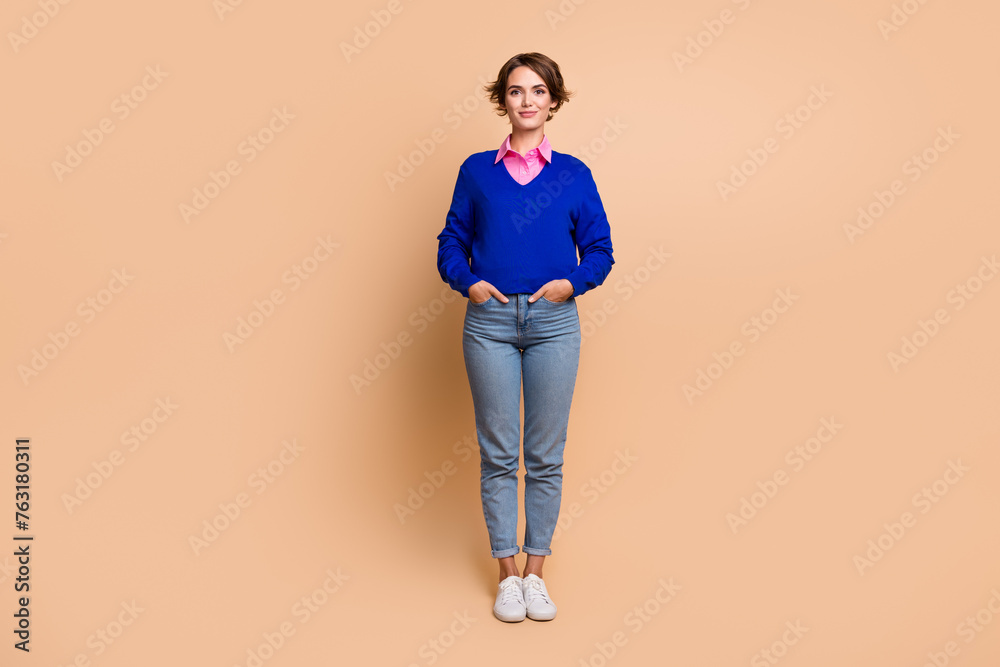 Full size photo of attractive young woman hands pockets shopping promo wear trendy blue clothes isolated on beige color background Full size photo of attractive young woman hands pockets shopping promo wear trendy blue clothes isolated on beige color background
