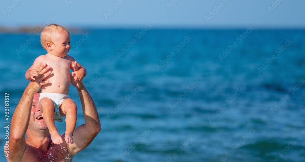 Father swim with baby child in the sea. Nature, travel, happy father and kid playing in ocean. Copy space for text or design. Horizontal image. Father swim with baby child in the sea. Nature, travel, happy father and kid playing in ocean. Copy space for text or design. Horizontal image.