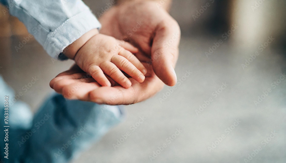 baby's hand grasping adult's hand, symbolizing trust and connection against clean background 