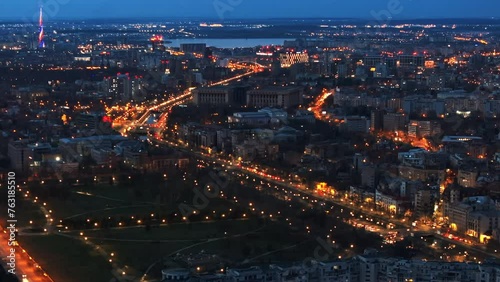 Aerial drone view of illuminated Bucharest cityscape in the evening. Moving traffic. Blue hour, Romania photo