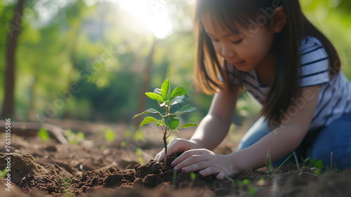 A girl planting a small tree global warming concept