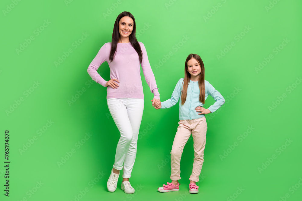 Full length photo of sweet cute mommy small girl wear casual outfits walking holding arms isolated green color background - obrazy, fototapety, plakaty 