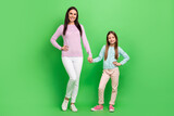Full length photo of sweet cute mommy small girl wear casual outfits walking holding arms isolated green color background
