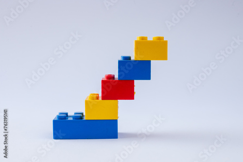 Closeup of Colorful Plastic Toy Brick Building Blocks arranged symmetrically on a White Background