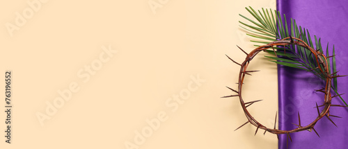 Crown of thorns with palm leaf and purple fabric on beige background. Good Friday concept © Pixel-Shot