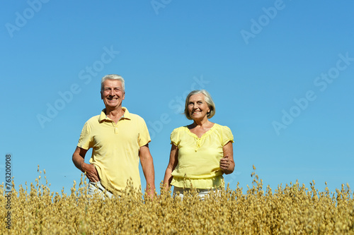Loving mature couple in field at summer