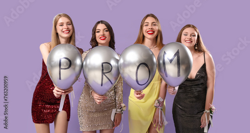 Young women holding balloon...