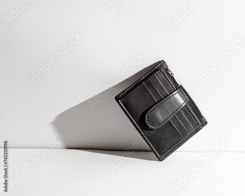 Black leather credit card wallet on white background.