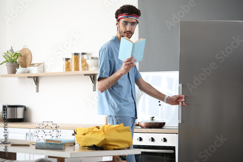 Male student with book open...