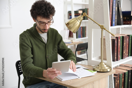 Male student studying with ...