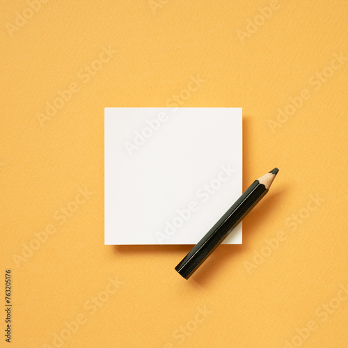 Obraz na płótnie White blank memo notepad and pencil on orange desk background. top view, copy space w salonie