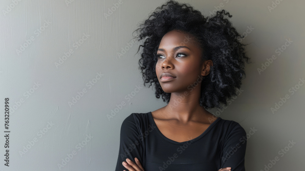 Black woman, arms crossed and standing isolated on gray background for confident profile or empowerment Black woman, arms crossed and standing isolated on gray background for confident profile or empowerment
