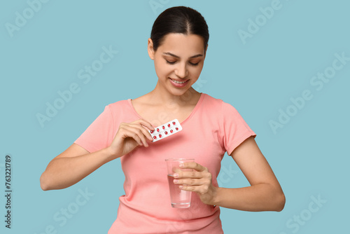 Pretty young woman holding ...
