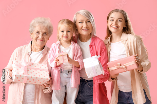 Little girl with her family and gifts on pink background