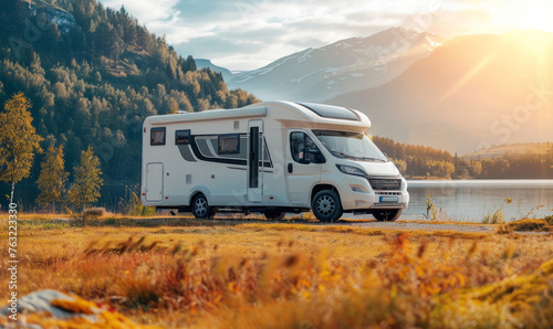 Campervan or motorhome parked in the autumn nature. Active family vacation.