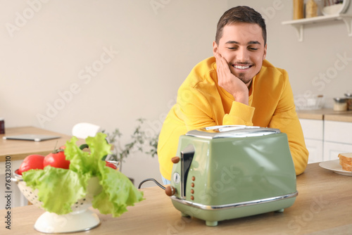 Young man waiting for toast...