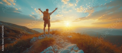 Hiker raised hands and enjoying sunrise