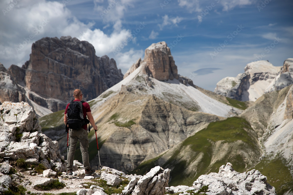 Stunning view of a tourist enjoying the view in the Tre Cime Di Lavaredo National park, Dolomites, Italy. Stunning view of a tourist enjoying the view in the Tre Cime Di Lavaredo National park, Dolomites, Italy.