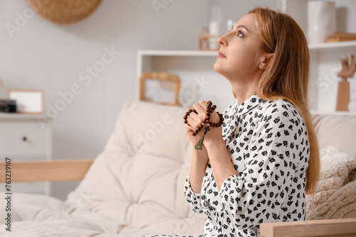 Mature woman praying with b...