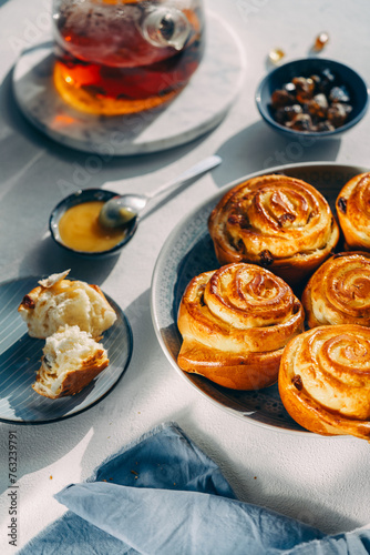 homemade pastries on a plate, light background, no people, close-up, cozy atmosphere, sunlight
