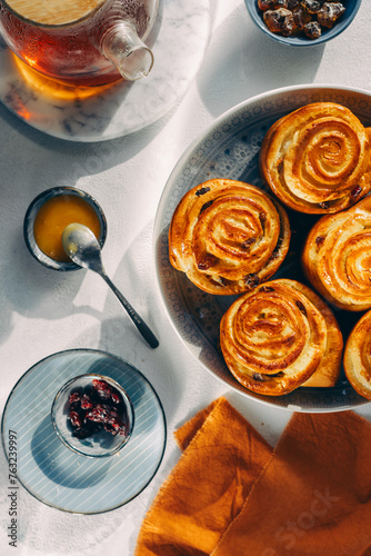 homemade pastries on a plate, light background, no people, close-up, cozy atmosphere, sunlight, top view