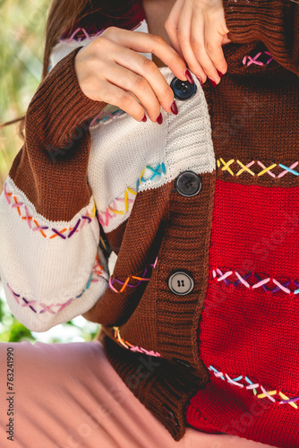 Beauty and fashion details: closeup of clothes and hands of brunette model with a fashion look (no face, copy space)