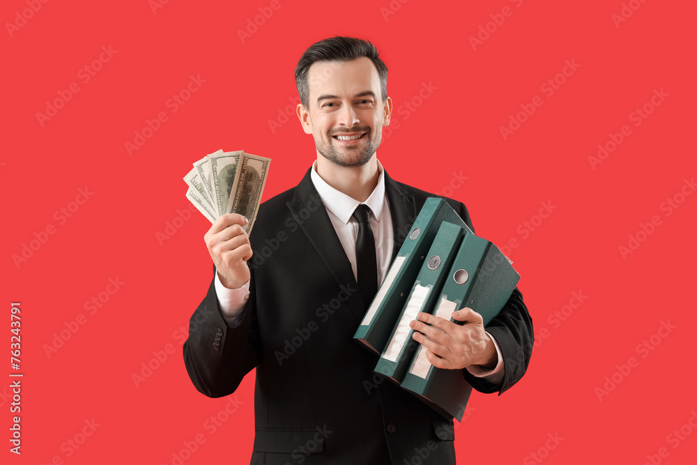 Portrait of male businessman with money and office folders on red background Portrait of male businessman with money and office folders on red background