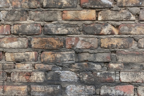Close-up of an old, multi-colored brick wall showing texture, weathering, and patterns