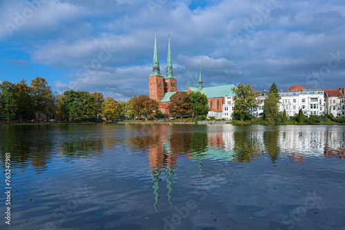 Lubeck, Germany. View of Lubeck Cathedral from the opposite shore of Muhlenteich (Mill pond) in autumn day. The cathedral was started in 1173 and consecrated in 1247.